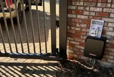 Gate operator and control equipment at a brick gatepost