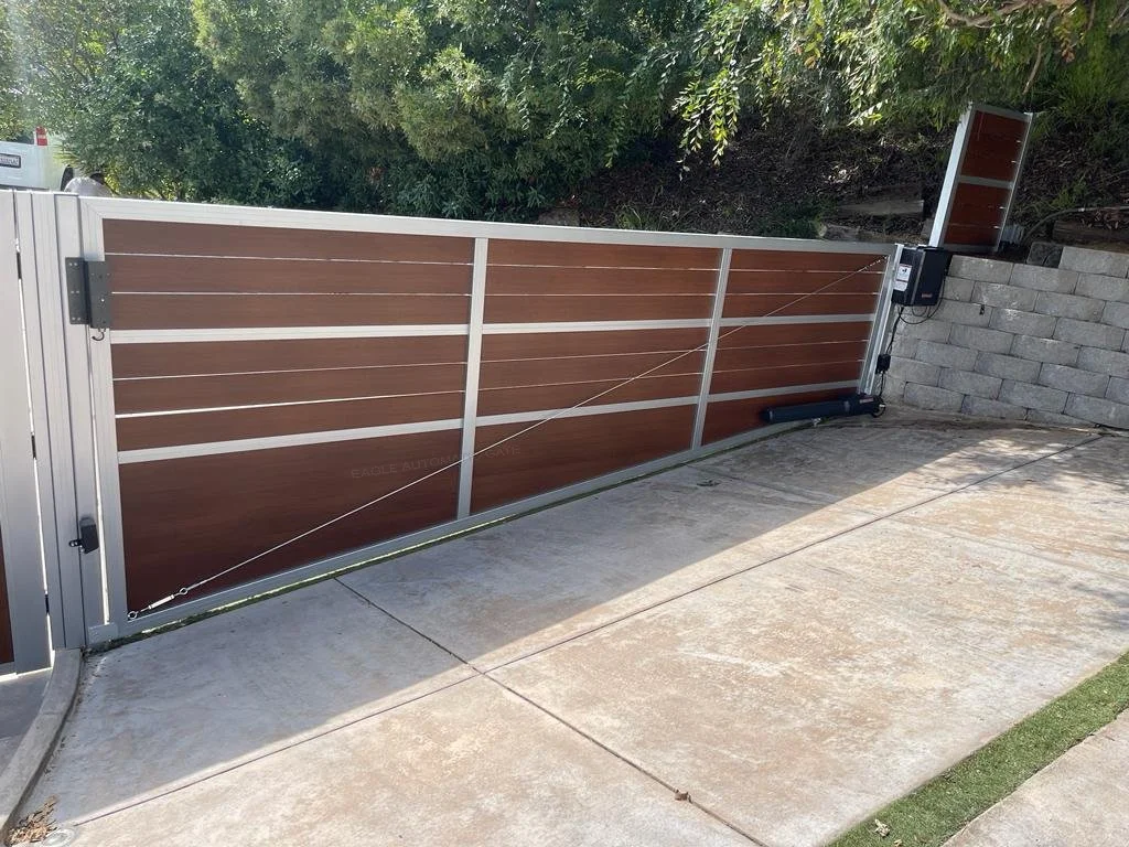 Wood-look sliding driveway gate with metal framing