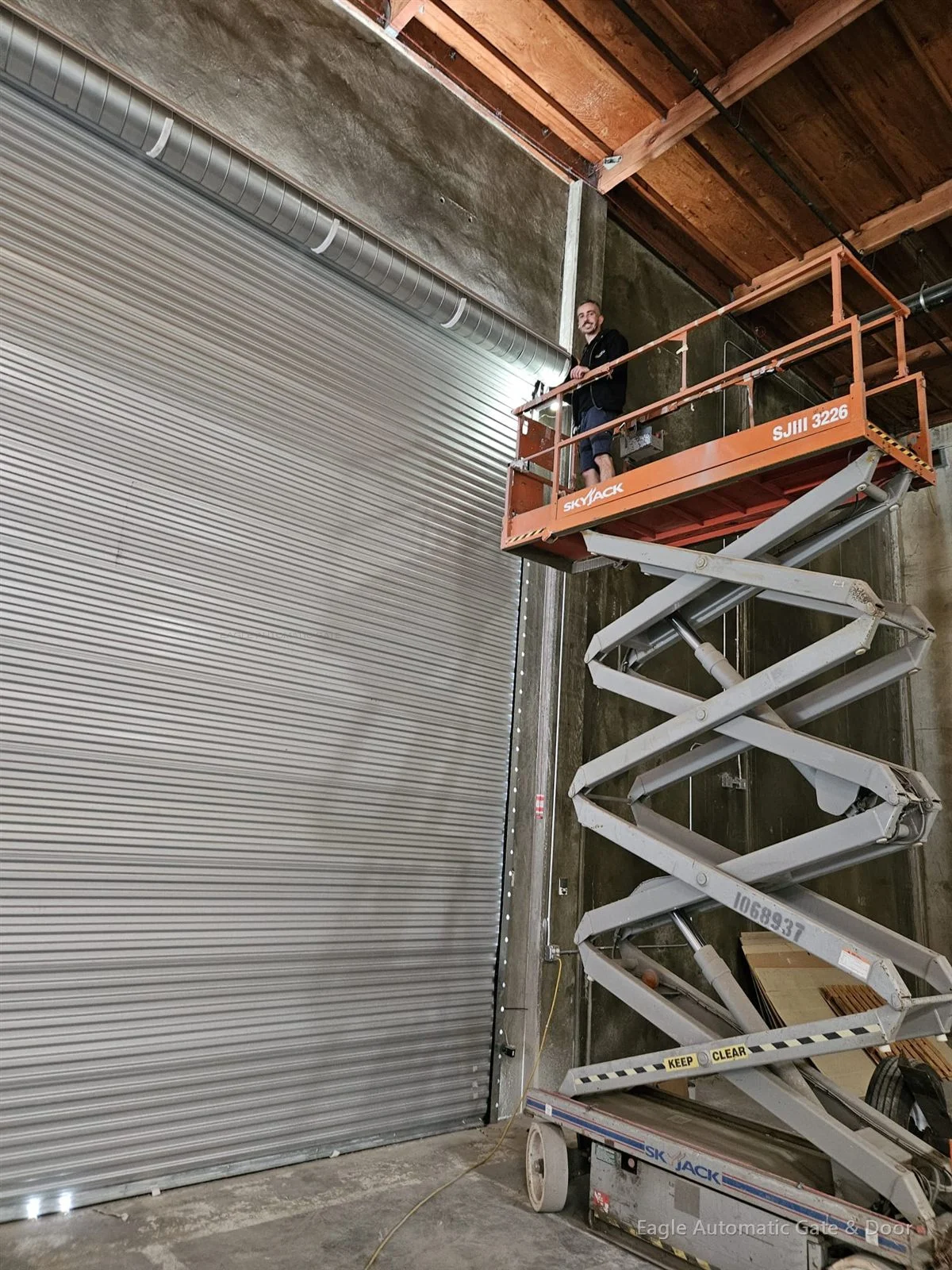 Installing the Gilroy roll-up door from a scissor lift