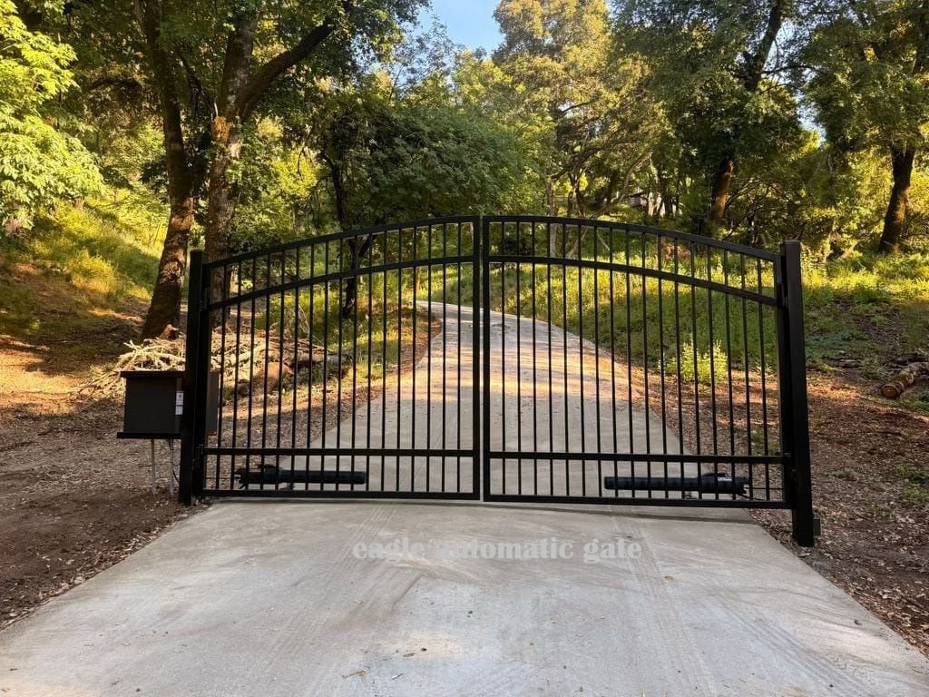 Completed arched iron driveway gate in Woodside