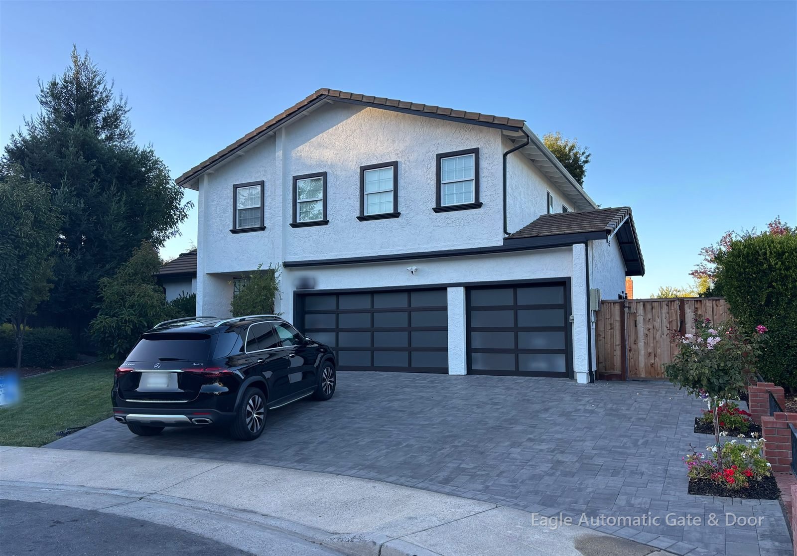 Completed glass garage doors across a two-story home