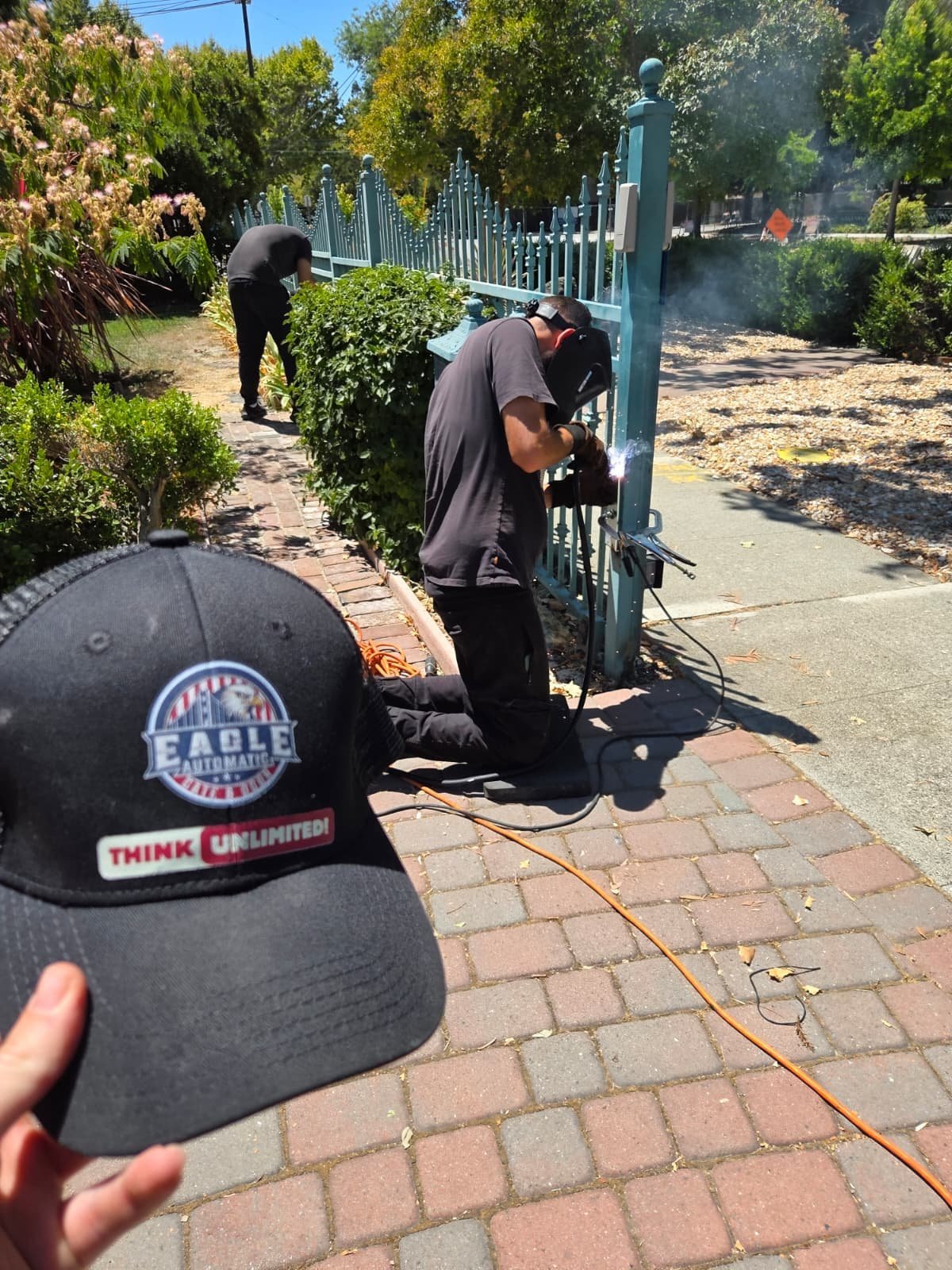 Eagle crew working on a metal driveway gate